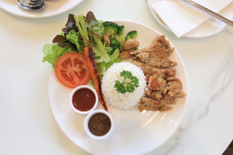 Grilled chicken sandwich with fresh vegetables at Dions